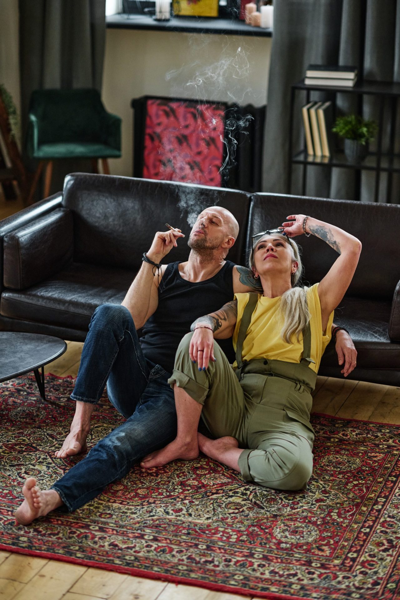 Couple smoking next to the couch